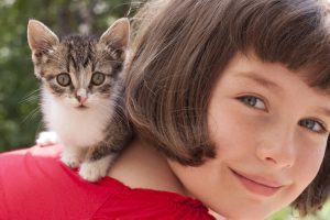 Child with kitten. Cat food and supplies available at Berend Bros. locations in Wichita Falls, Bowie, Megargel, Windthorst, and Olney, Texas